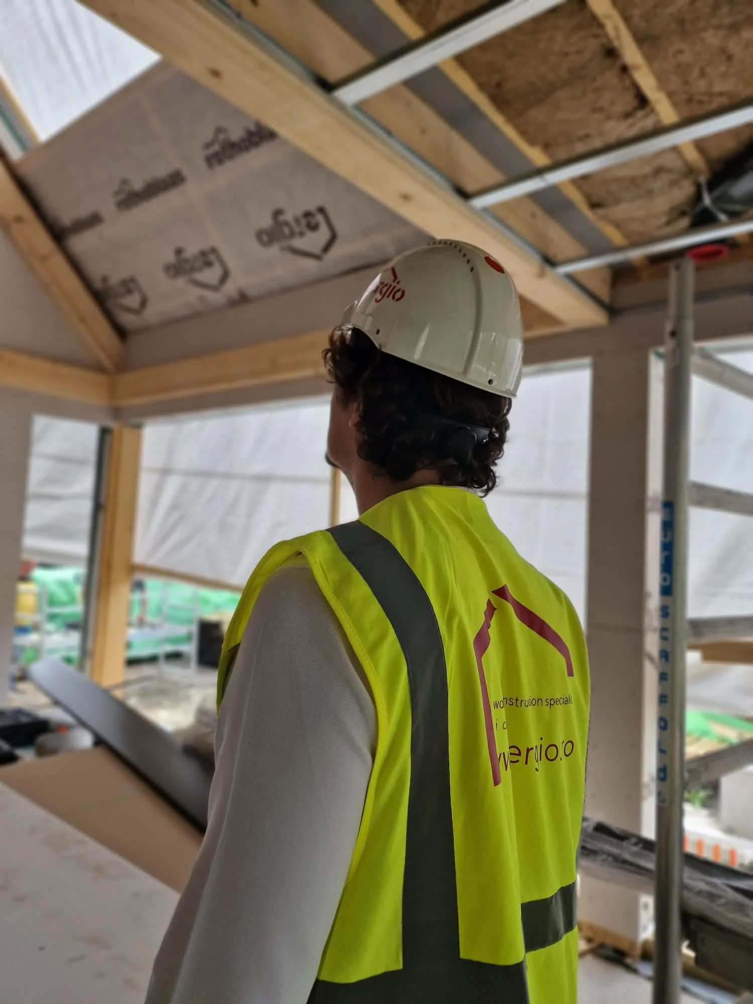 ERGIO site technician inspecting timber assembly and envelope installation