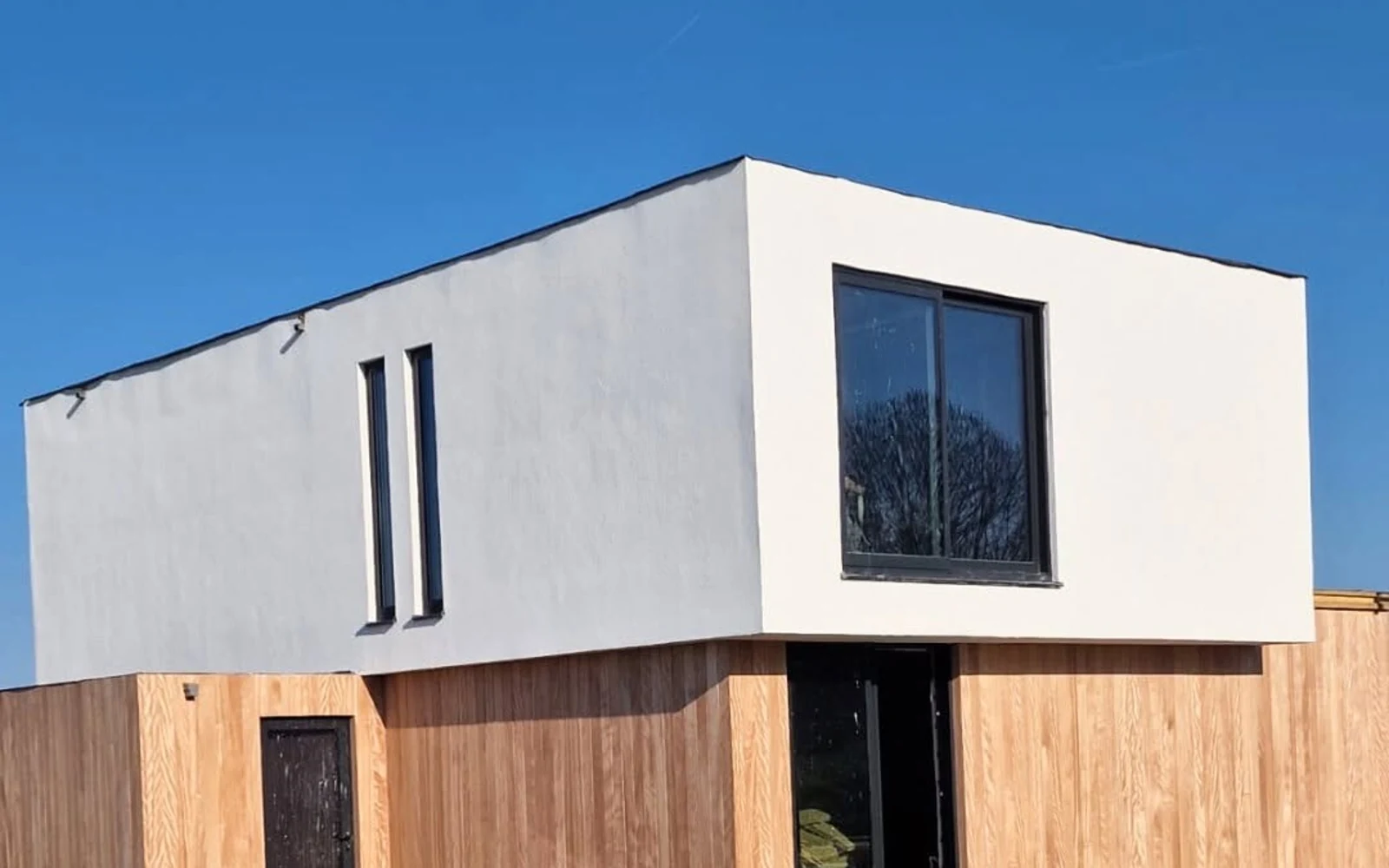 Wide on-site view of the Dutch contemporary timber residence