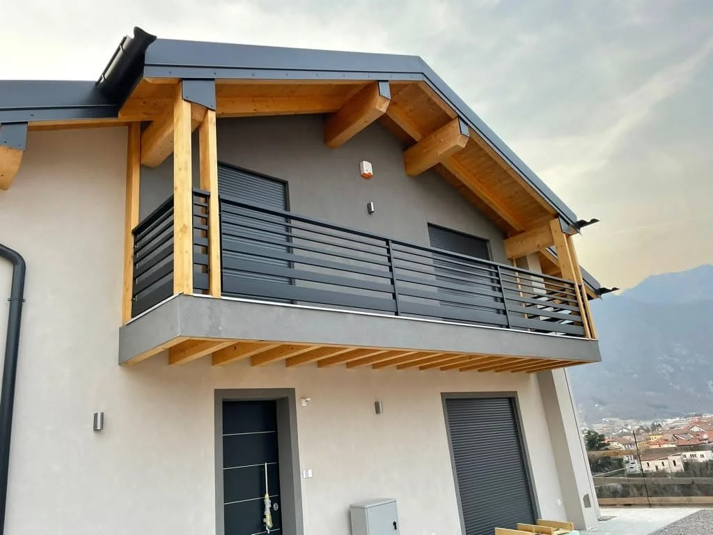 Completed Ponte Nelle Alpi residence with exposed timber balcony structure