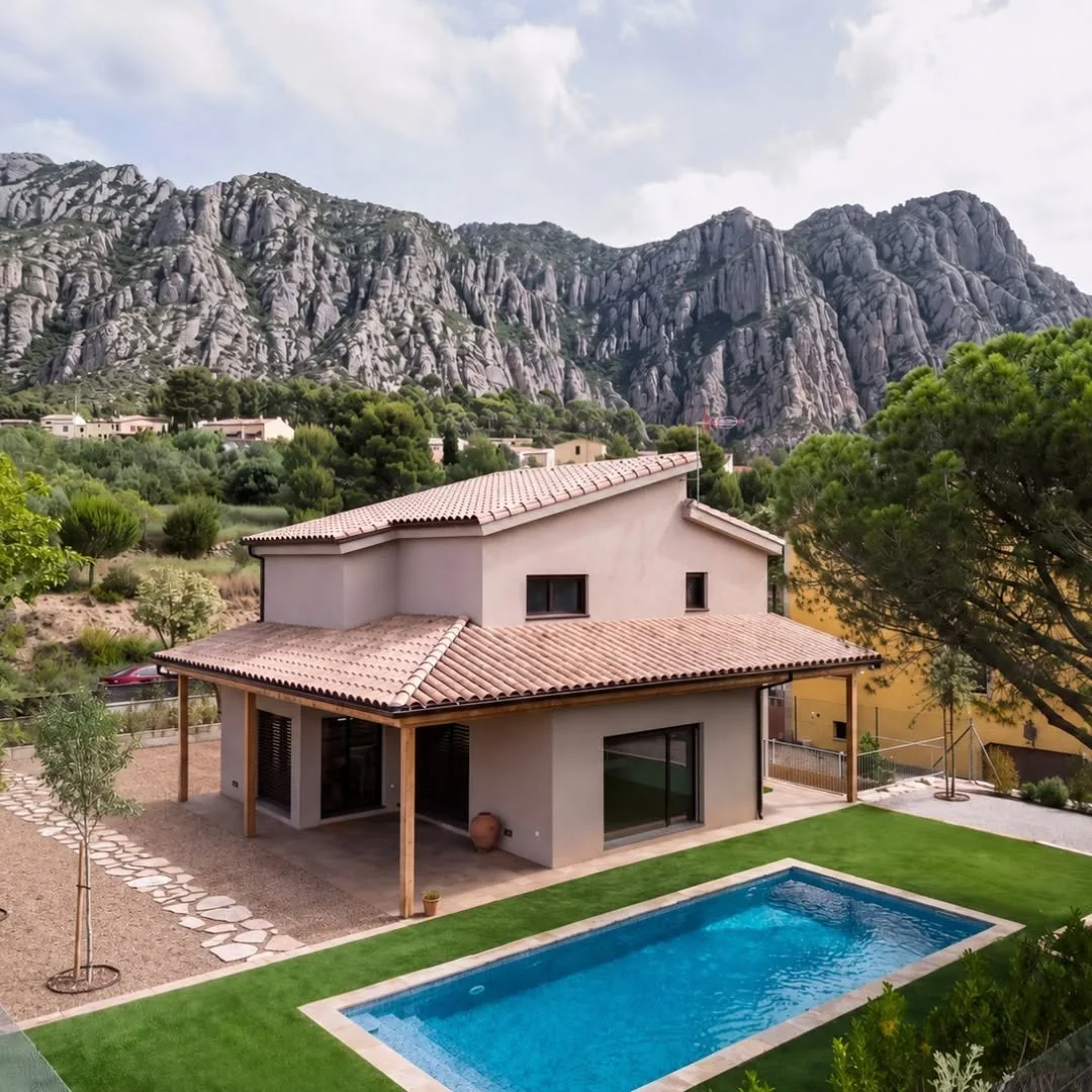 Completed timber frame residence with a swimming pool in a mountainous setting