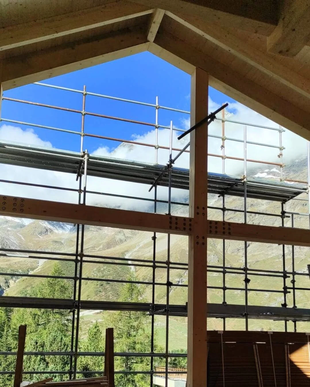 Visible timber frame and Alpine view inside the Valle d’Aosta hotel complex